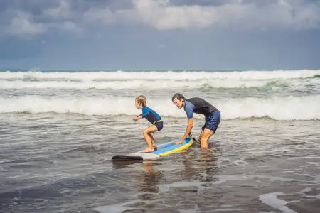 dad and kid surfing