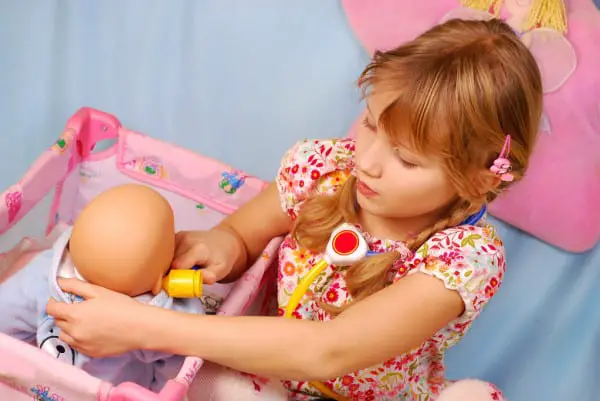 girl playing baby doll